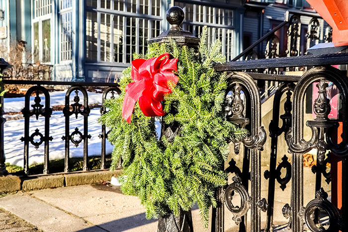 Christmas Wreath Hanging From Wrought Iron Fence