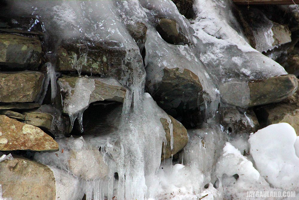 Icicles Coming From Rock Wall