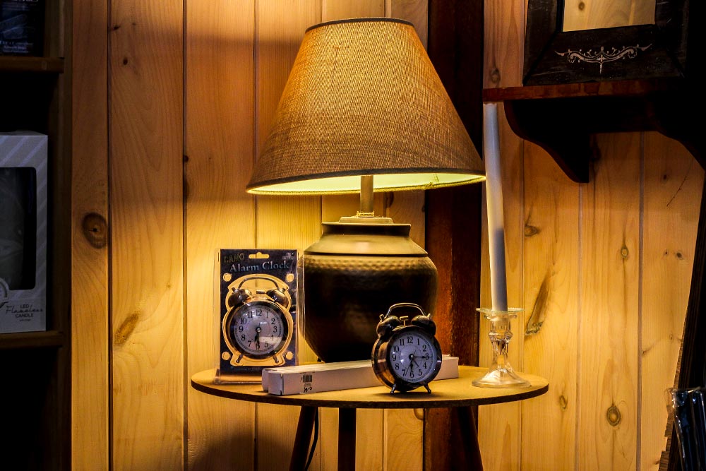 Lamp & Alarm Clocks on Small Table in Corner