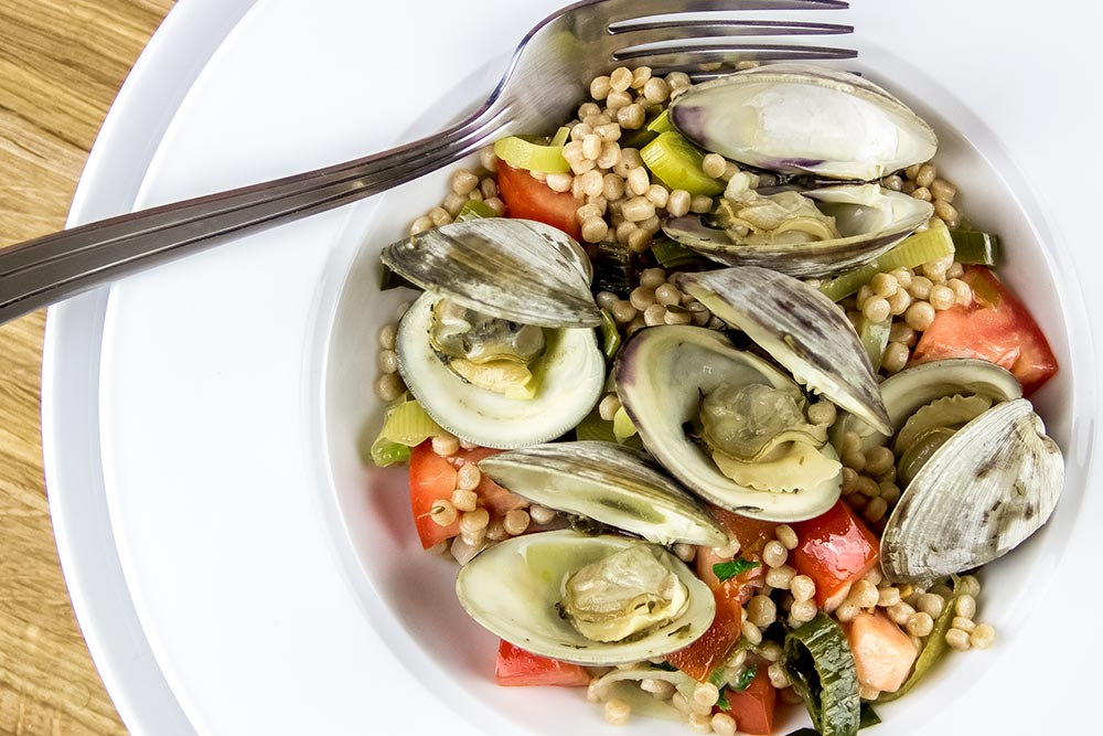 Steamed Littleneck Clams with Pearl Couscous, Leeks & Tomatoes Recipe