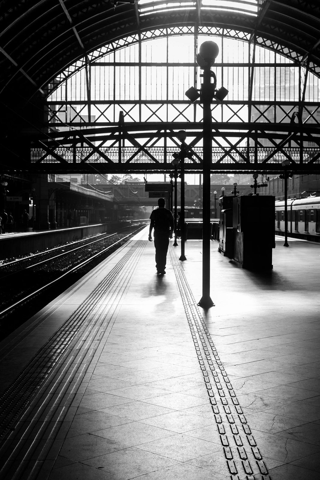Man Walking at Train Station