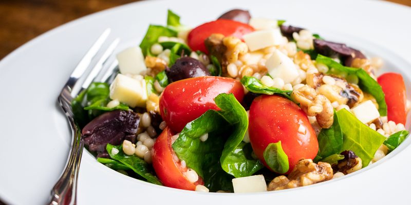 Pearl Couscous Salad with Tomatoes, Spinach, & Walnuts Recipe