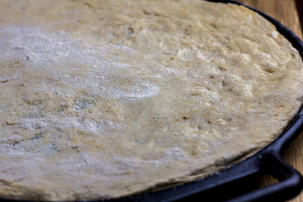Stretched Pizza Dough on Cast Iron Pan