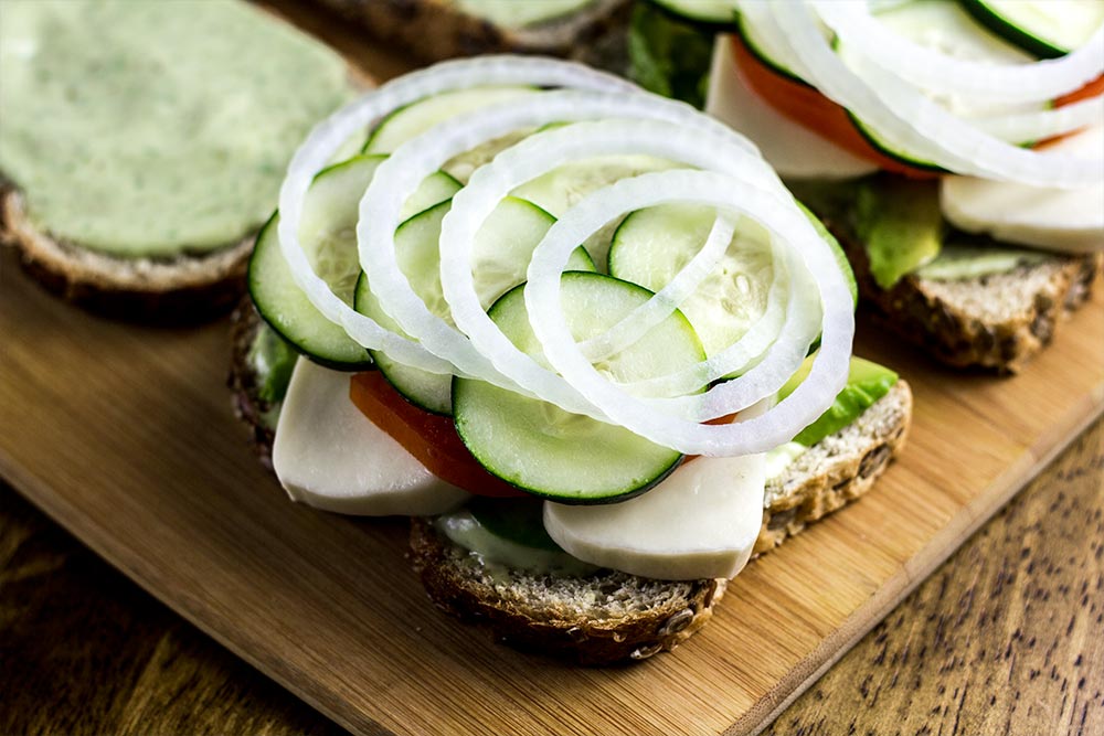 Adding Onion Slices to Sandwich