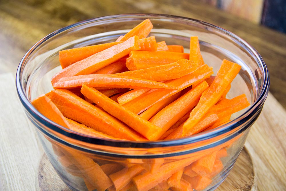Sliced Carrots in Large Glass Bowl