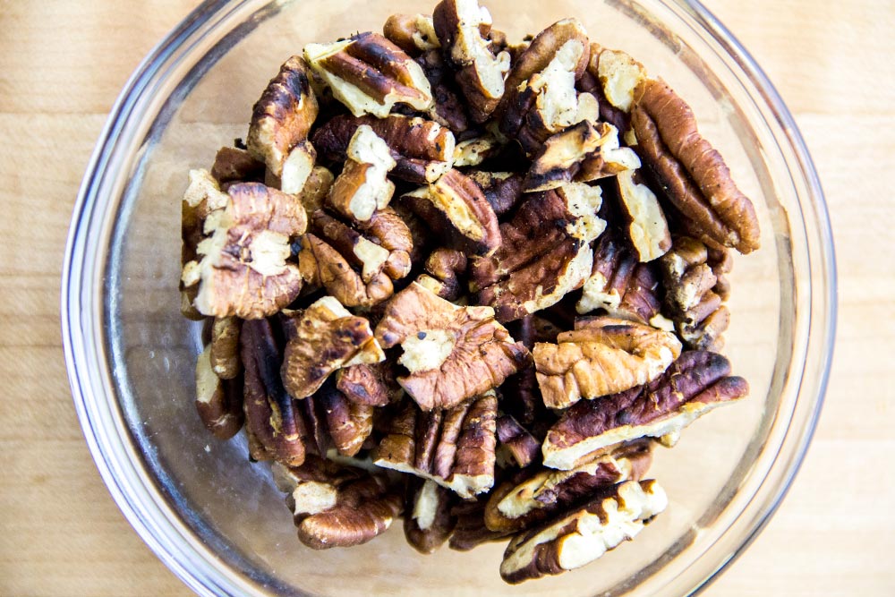 Coarsely Chopped & Toasted Pecans in Glass Bowl