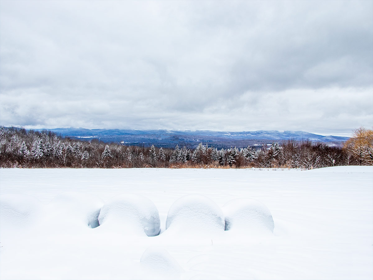 Snow Covered Field in Front of Western Maine Mountains